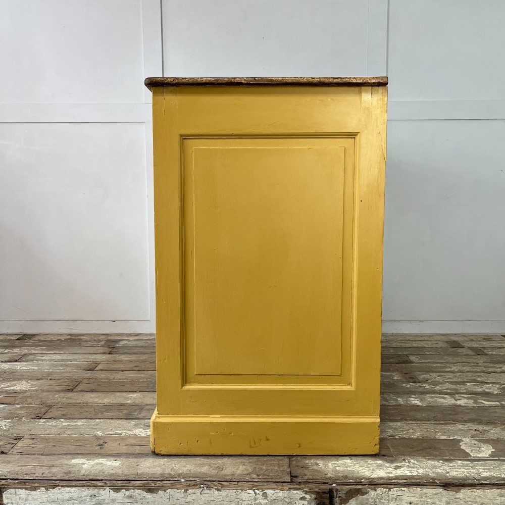 A large Victorian pine school cupboard featuring a mustard yellow painted finish, two panelled doors with wooden knobs, and a dark waxed wooden top. View IX