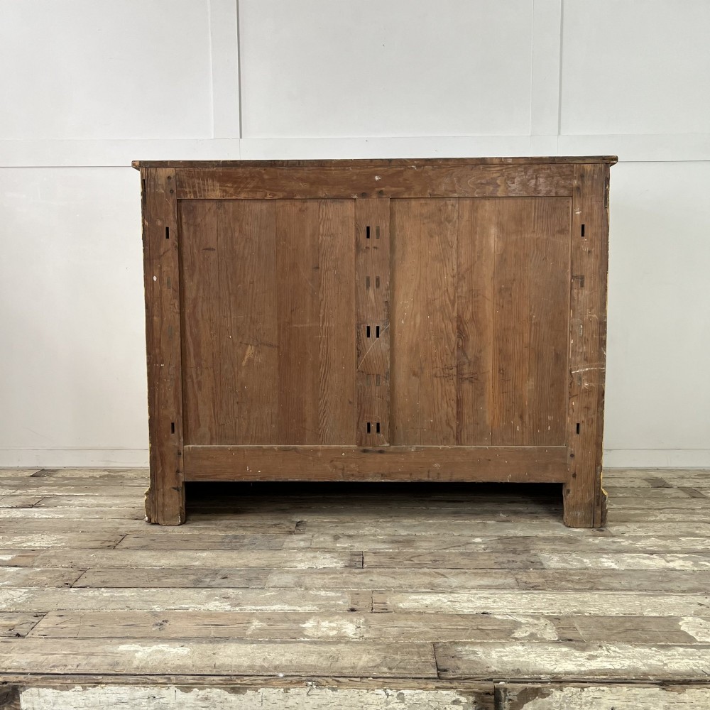 A large Victorian pine school cupboard featuring a mustard yellow painted finish, two panelled doors with wooden knobs, and a dark waxed wooden top. View X