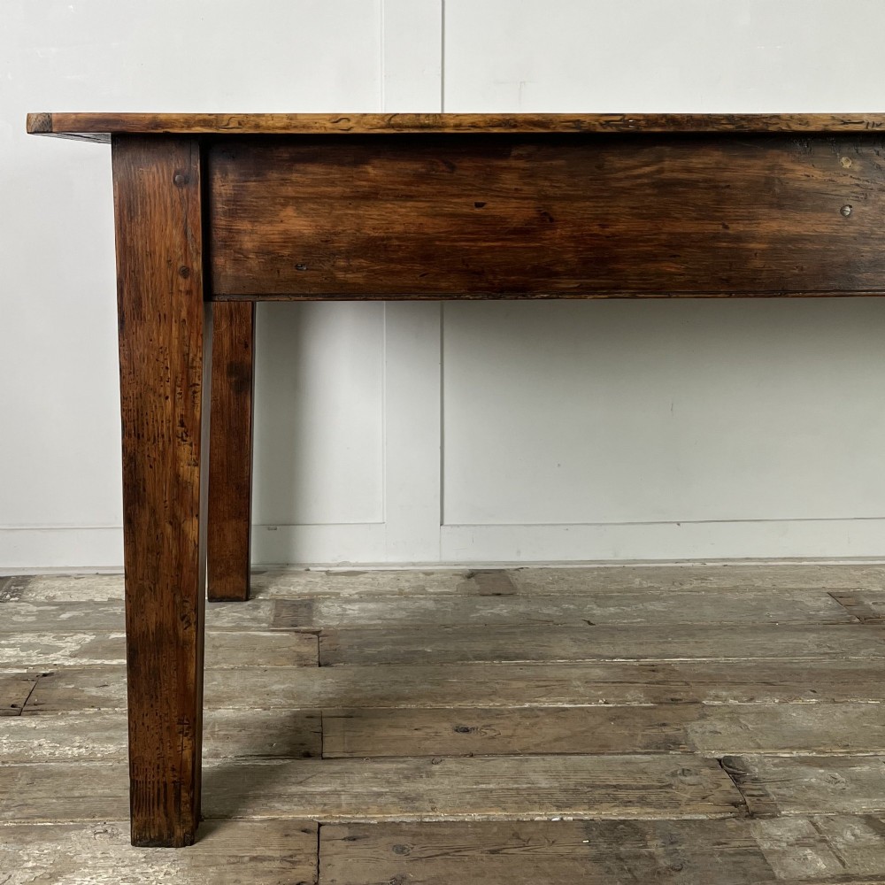 A long 19th-century pine farmhouse dining table with tapered square legs and a warm brown waxed finish. View II