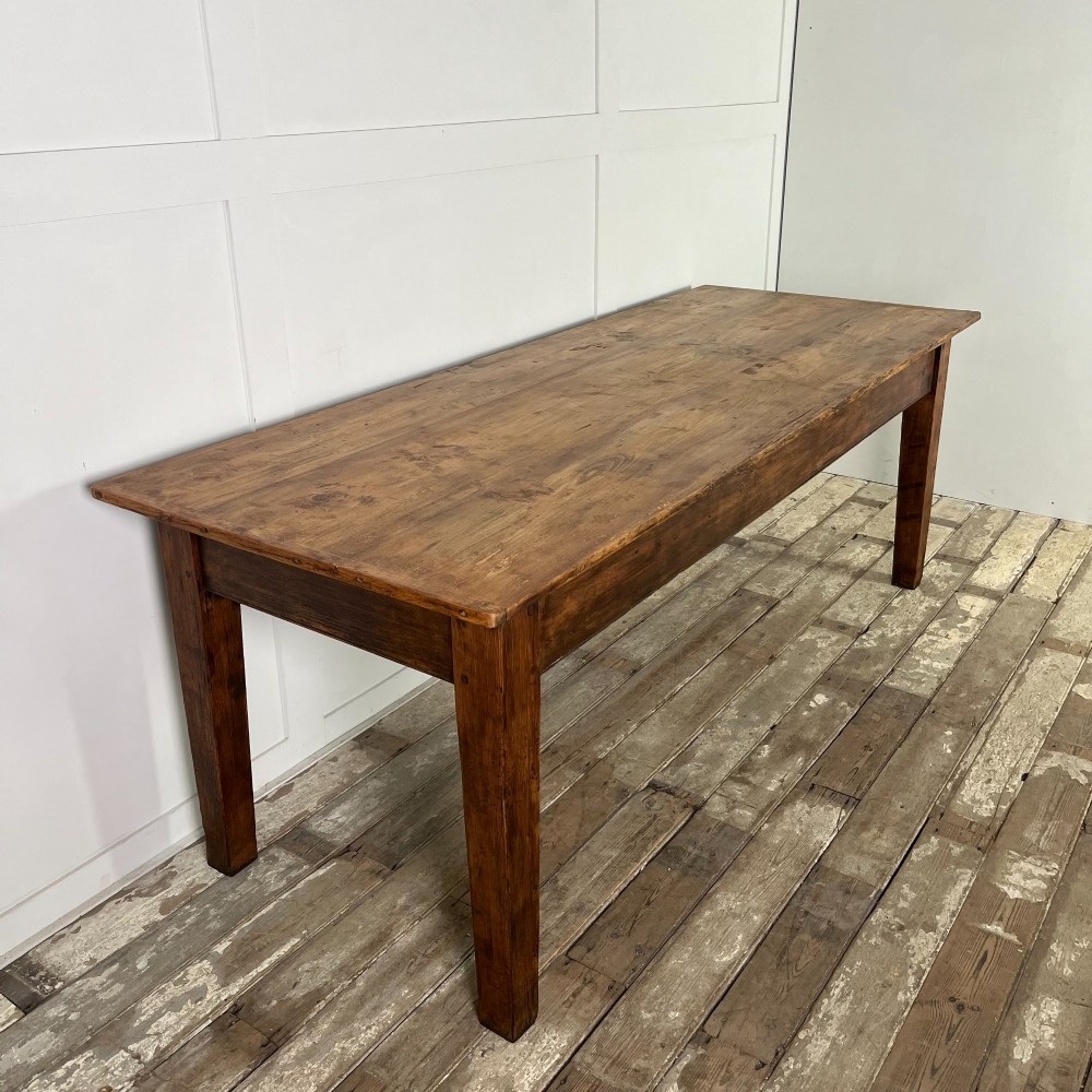 A long 19th-century pine farmhouse dining table with tapered square legs and a warm brown waxed finish. View III