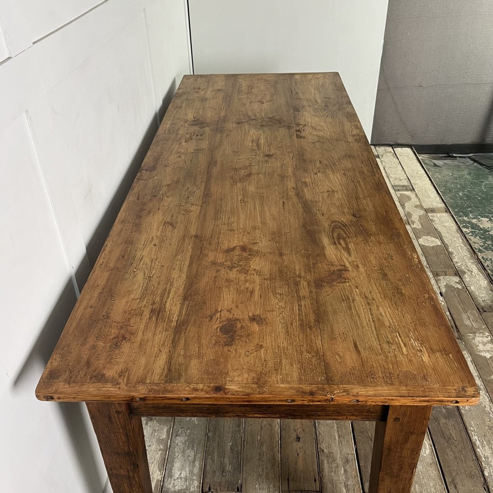 A long 19th-century pine farmhouse dining table with tapered square legs and a warm brown waxed finish. View IV