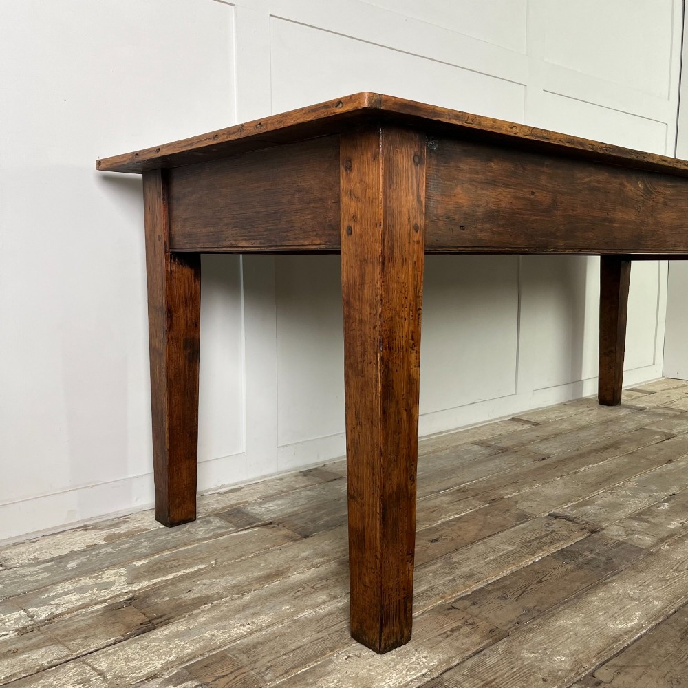 A long 19th-century pine farmhouse dining table with tapered square legs and a warm brown waxed finish. View V