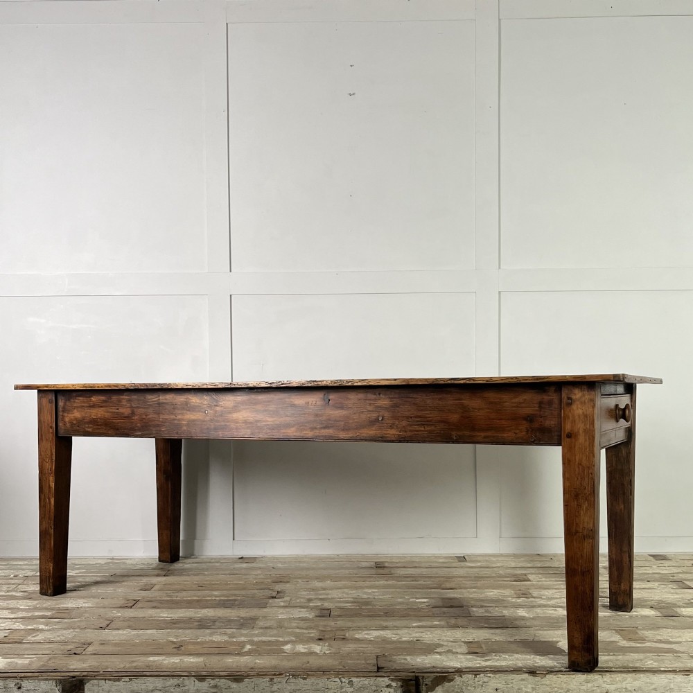 A long 19th-century pine farmhouse dining table with tapered square legs and a warm brown waxed finish. View VI