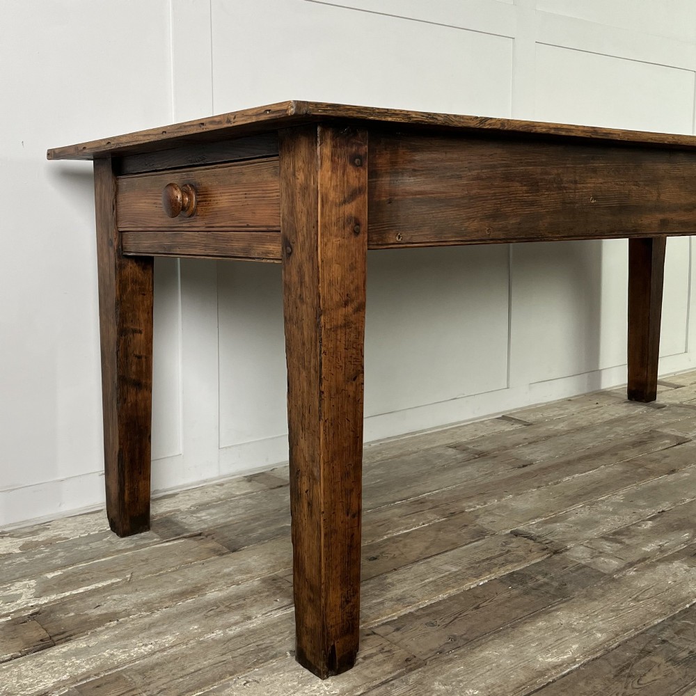 A long 19th-century pine farmhouse dining table with tapered square legs and a warm brown waxed finish. View VII