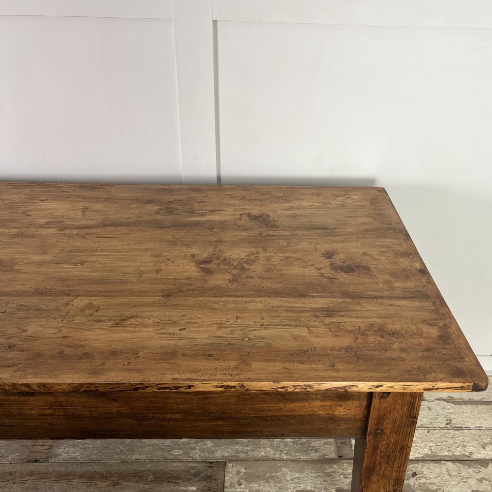 A long 19th-century pine farmhouse dining table with tapered square legs and a warm brown waxed finish. View XII