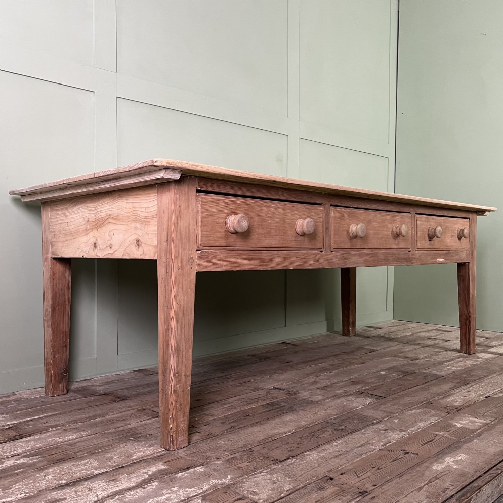 An early nineteenth-century timber prep table featuring three drawers with round wooden knobs set above four tapered legs. View II
