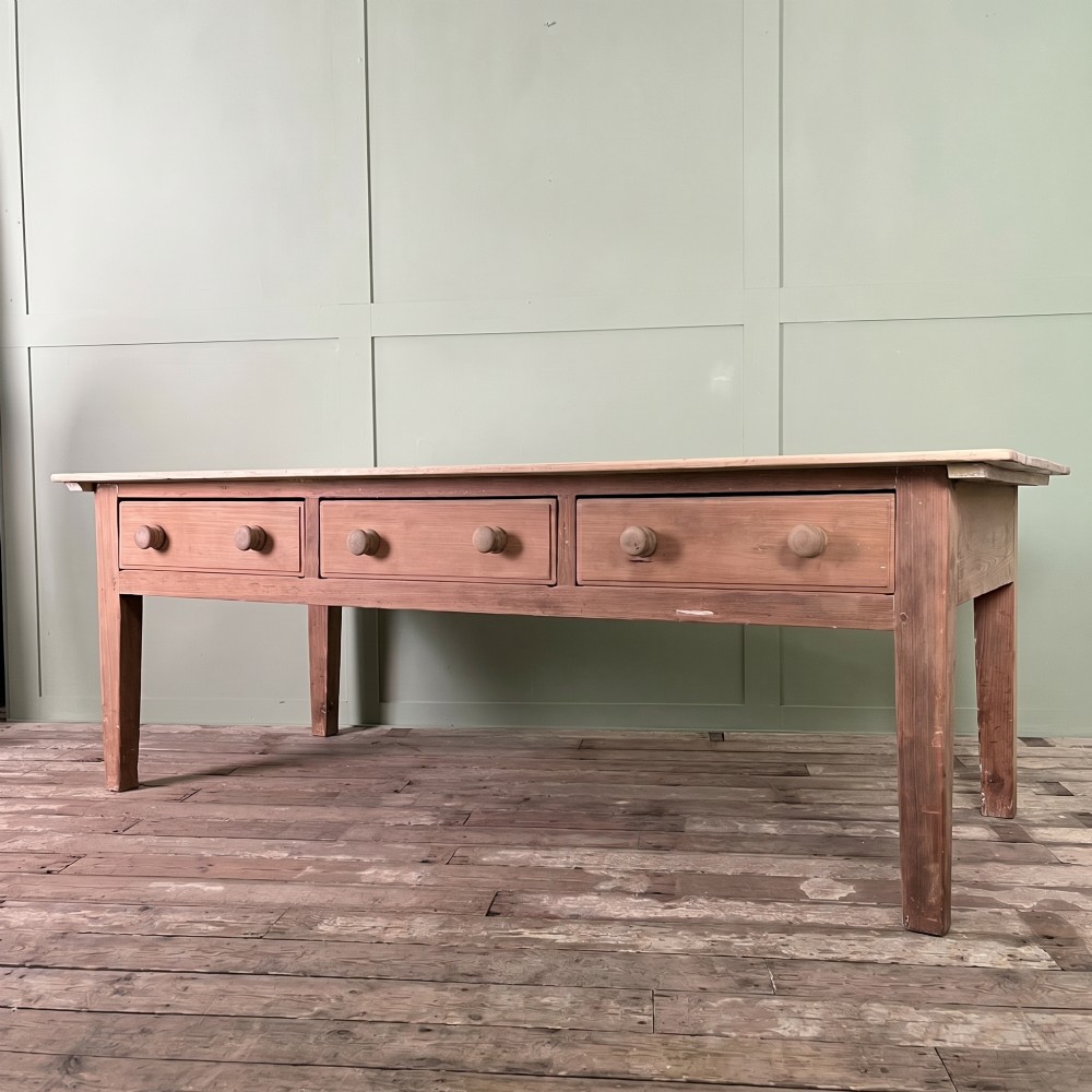 An early nineteenth-century timber prep table featuring three drawers with round wooden knobs set above four tapered legs. View III
