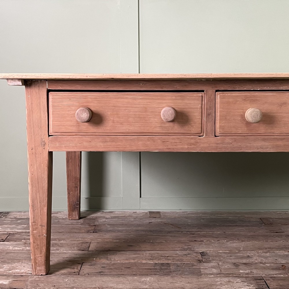 An early nineteenth-century timber prep table featuring three drawers with round wooden knobs set above four tapered legs. View VI