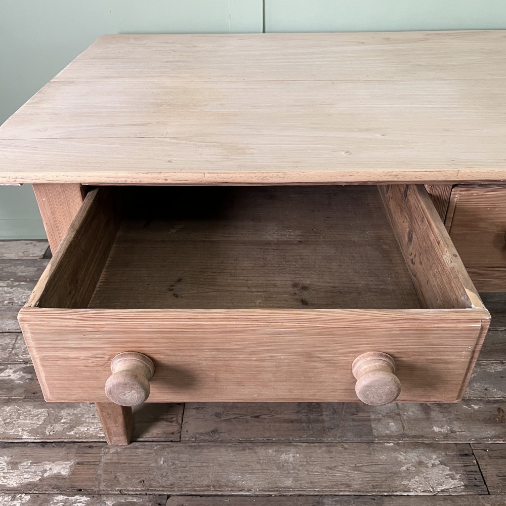An early nineteenth-century timber prep table featuring three drawers with round wooden knobs set above four tapered legs. View VII