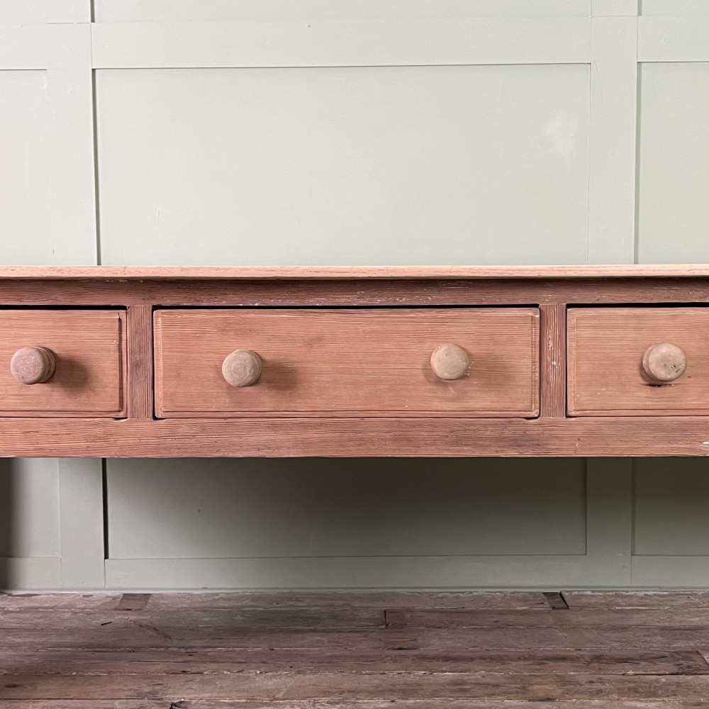 An early nineteenth-century timber prep table featuring three drawers with round wooden knobs set above four tapered legs. View VIII