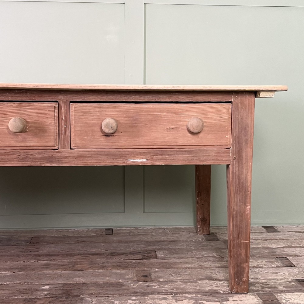 An early nineteenth-century timber prep table featuring three drawers with round wooden knobs set above four tapered legs. View IX