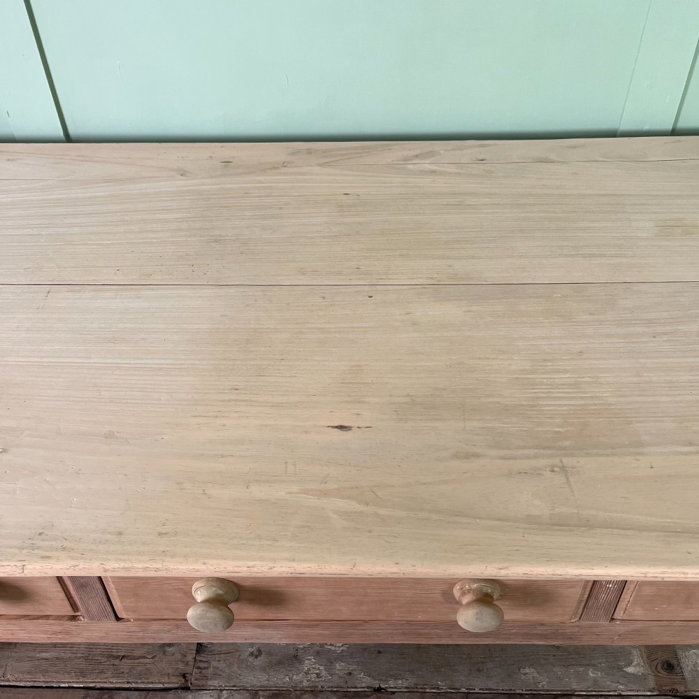 An early nineteenth-century timber prep table featuring three drawers with round wooden knobs set above four tapered legs. View XI