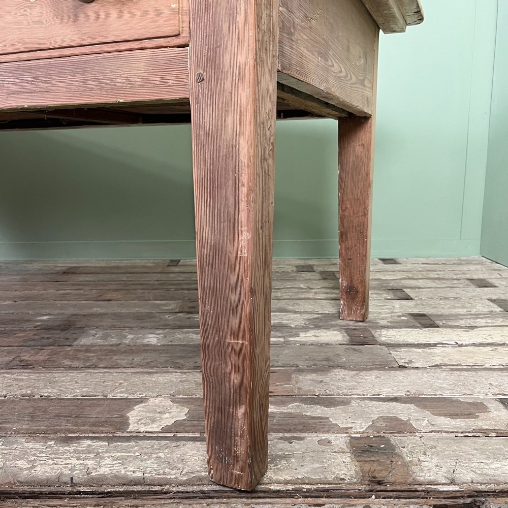 An early nineteenth-century timber prep table featuring three drawers with round wooden knobs set above four tapered legs. View XIII