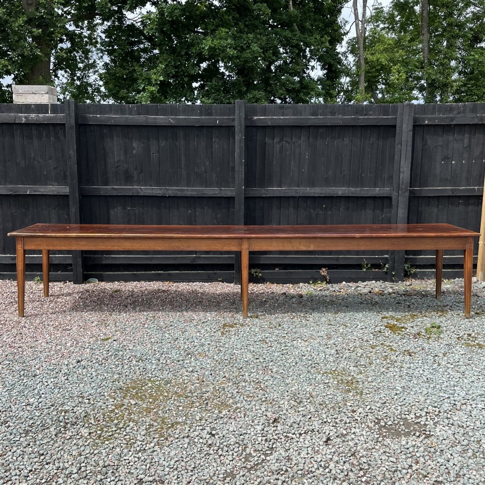 A 3.8-metre long 19th-century French cherrywood farmhouse dining table supported by six tapered square legs. View II