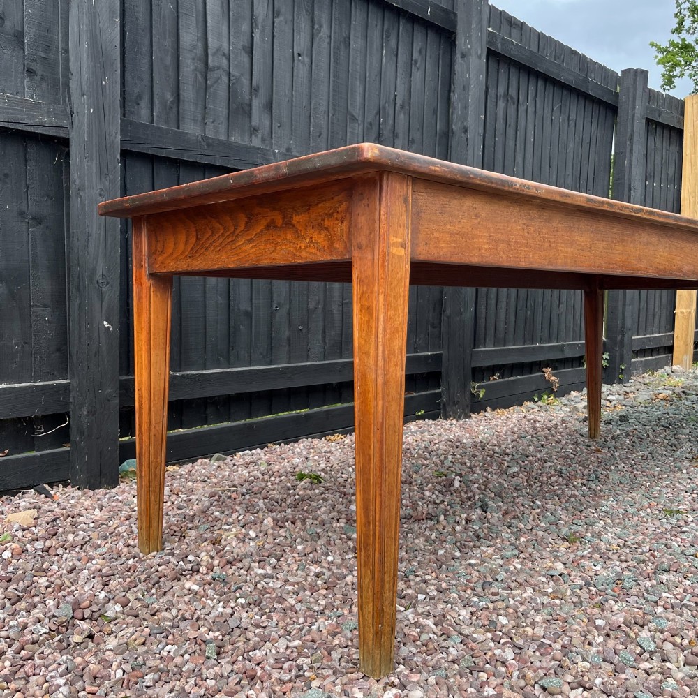 A 3.8-metre long 19th-century French cherrywood farmhouse dining table supported by six tapered square legs. View III