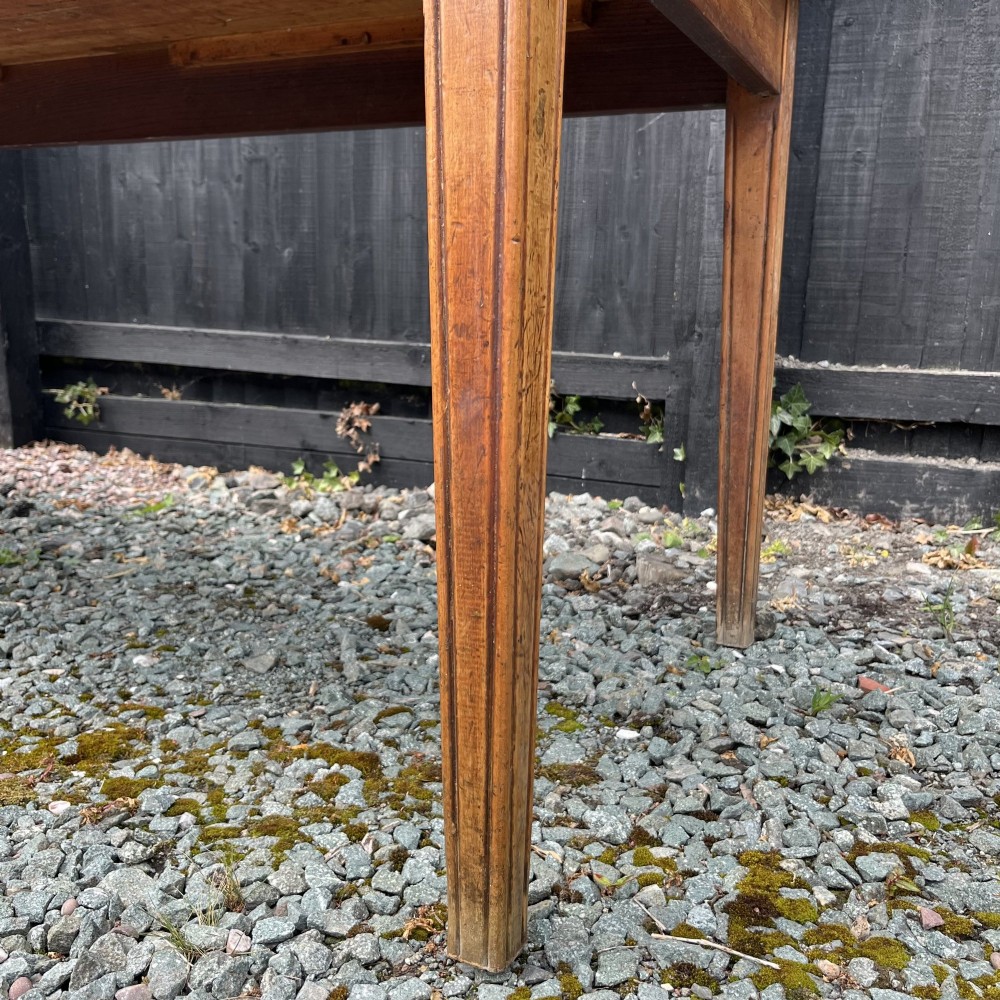 A 3.8-metre long 19th-century French cherrywood farmhouse dining table supported by six tapered square legs. View V
