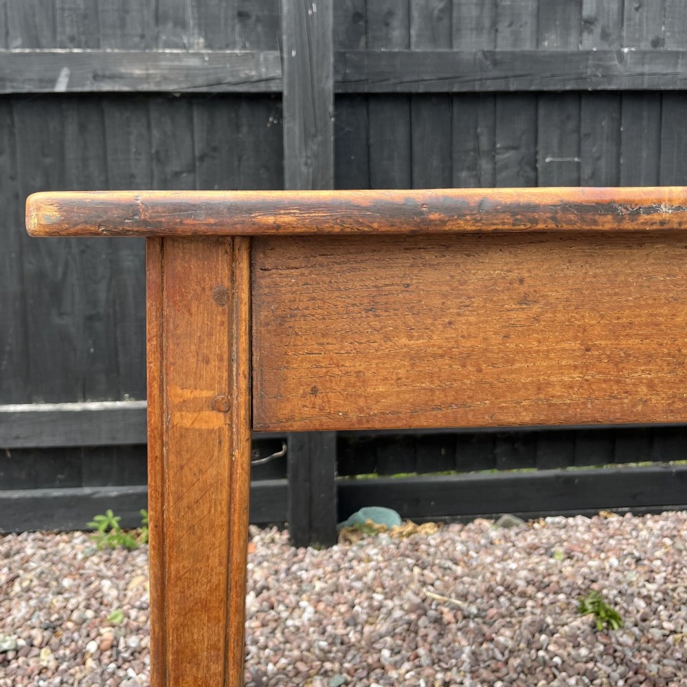 A 3.8-metre long 19th-century French cherrywood farmhouse dining table supported by six tapered square legs. View VI