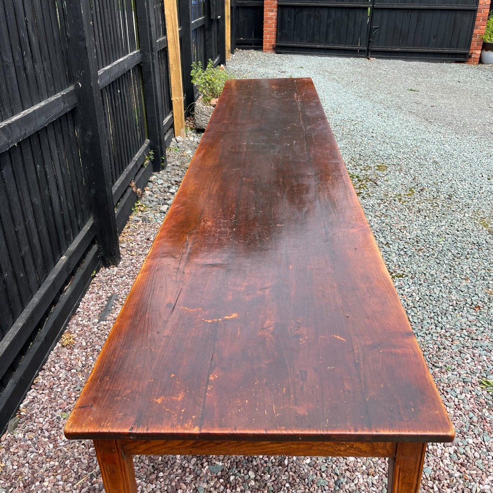 A 3.8-metre long 19th-century French cherrywood farmhouse dining table supported by six tapered square legs. View VII