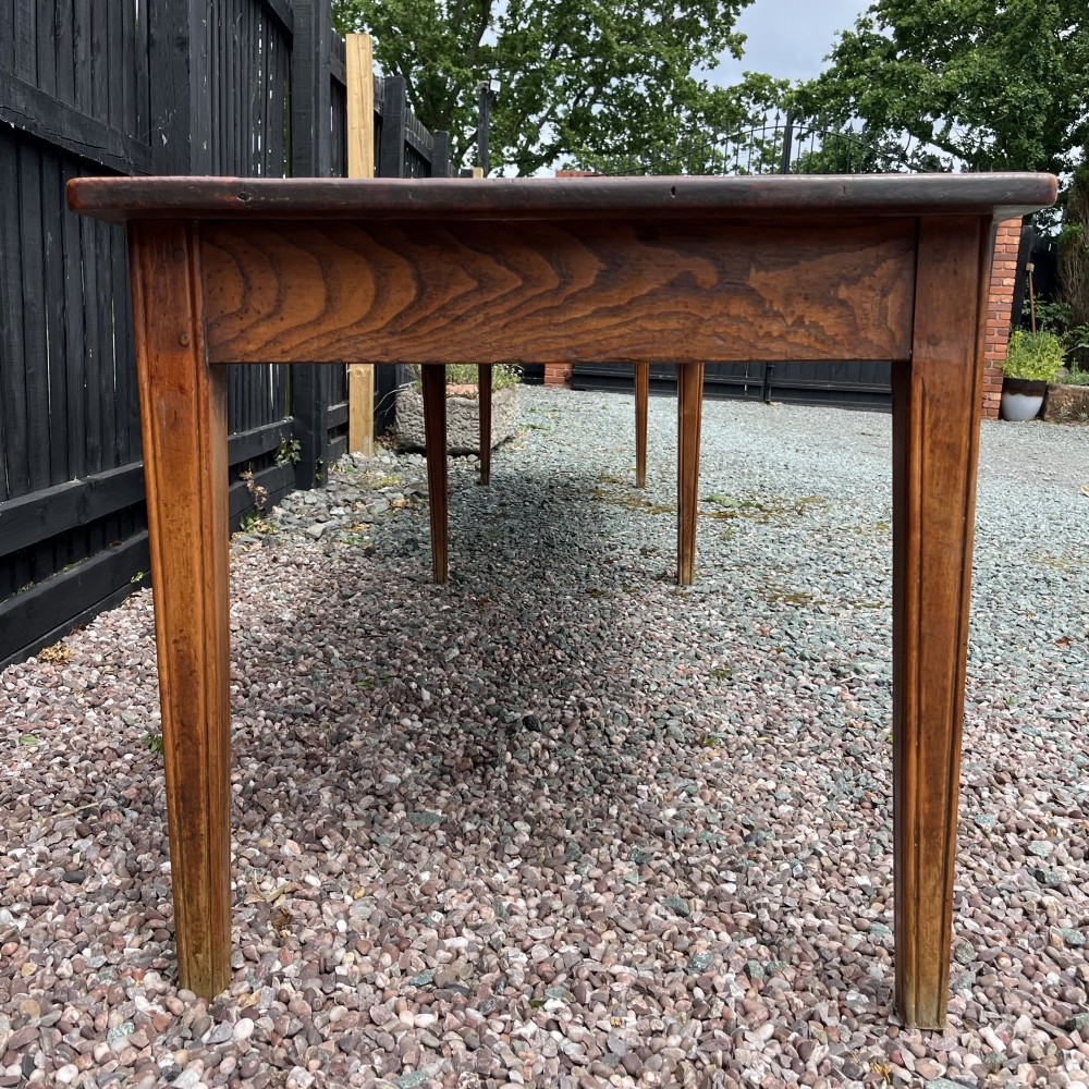 A 3.8-metre long 19th-century French cherrywood farmhouse dining table supported by six tapered square legs. View IX