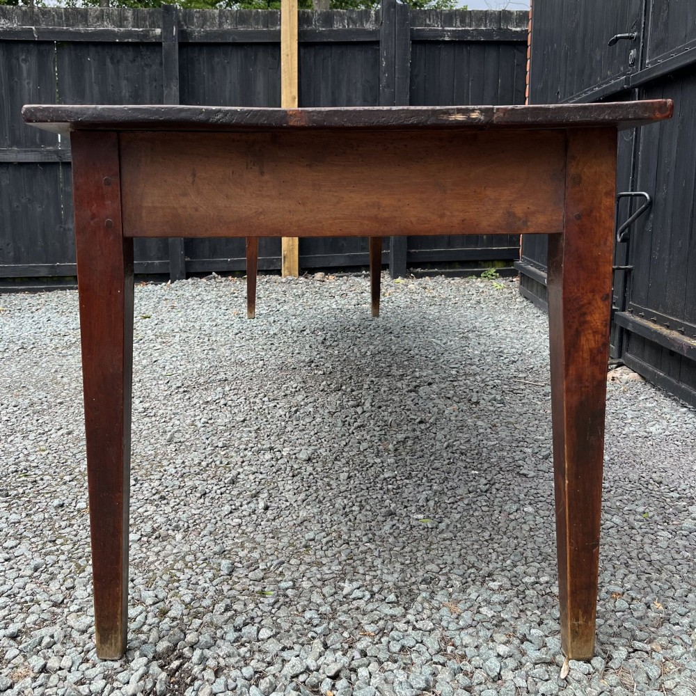 An exceptionally long 19th-century French cherrywood farmhouse table featuring a flat wooden top, straight aprons, and four square tapered legs. View III