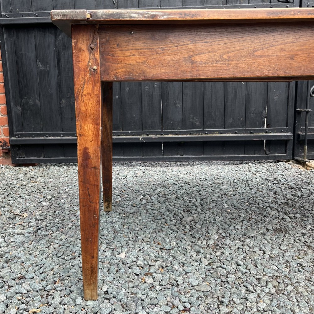 An exceptionally long 19th-century French cherrywood farmhouse table featuring a flat wooden top, straight aprons, and four square tapered legs. View IV