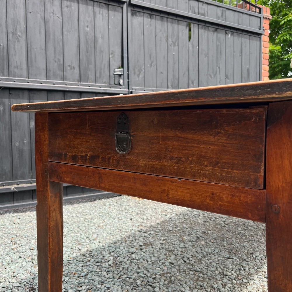 An exceptionally long 19th-century French cherrywood farmhouse table featuring a flat wooden top, straight aprons, and four square tapered legs. View VI