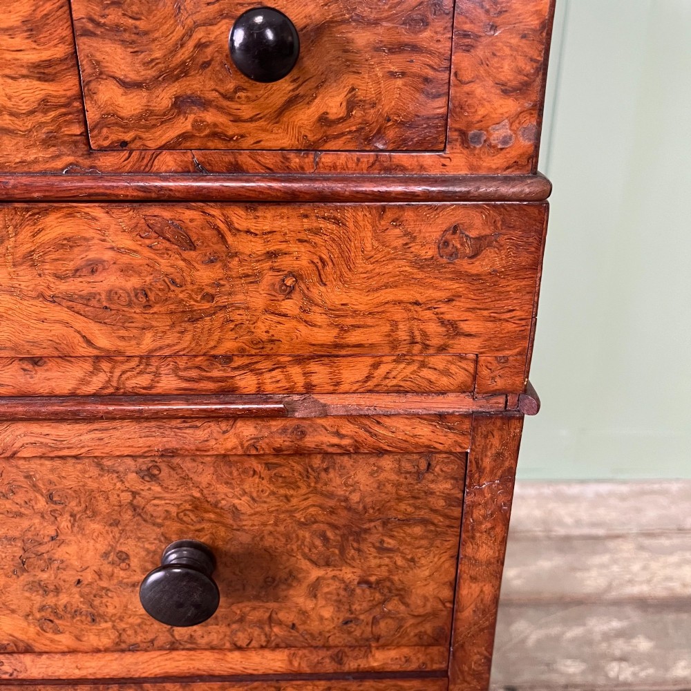 A 19th-century burr walnut Davenport desk featuring a sloped writing lid with a spindled gallery rail, side drawers, and turned feet. View VIII