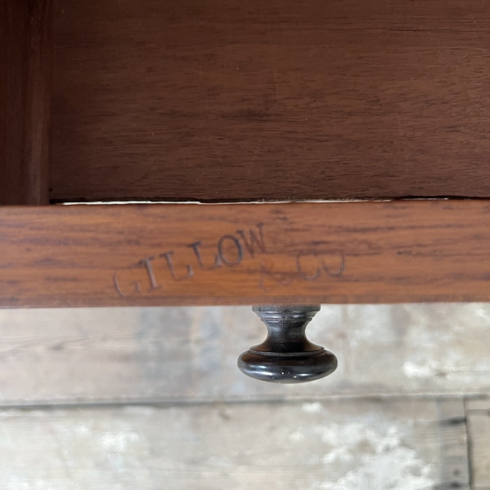 A 19th-century burr walnut Davenport desk featuring a sloped writing lid with a spindled gallery rail, side drawers, and turned feet. View XV