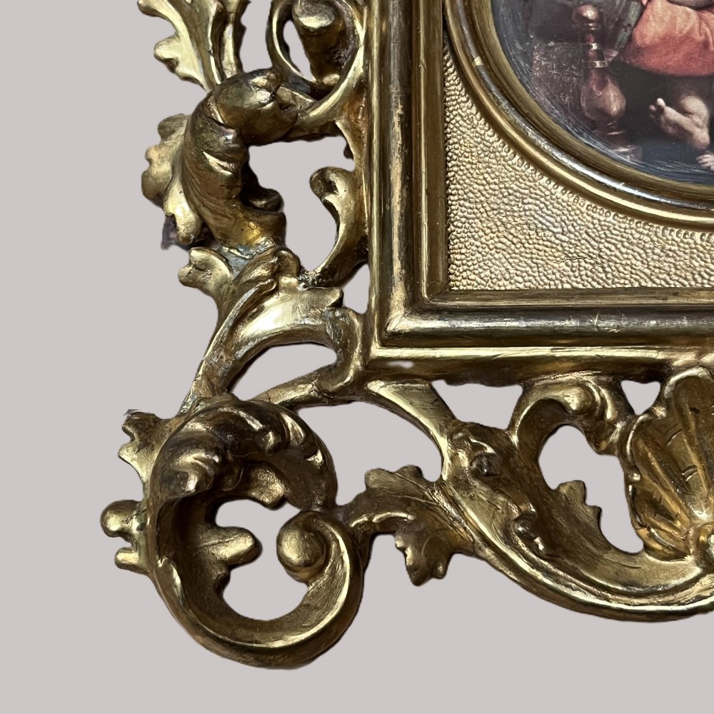 A 19th-century Florentine carved giltwood picture frame featuring openwork acanthus leaves, scrollwork cresting, and a central circular image of the Madonna and Child. View VIII