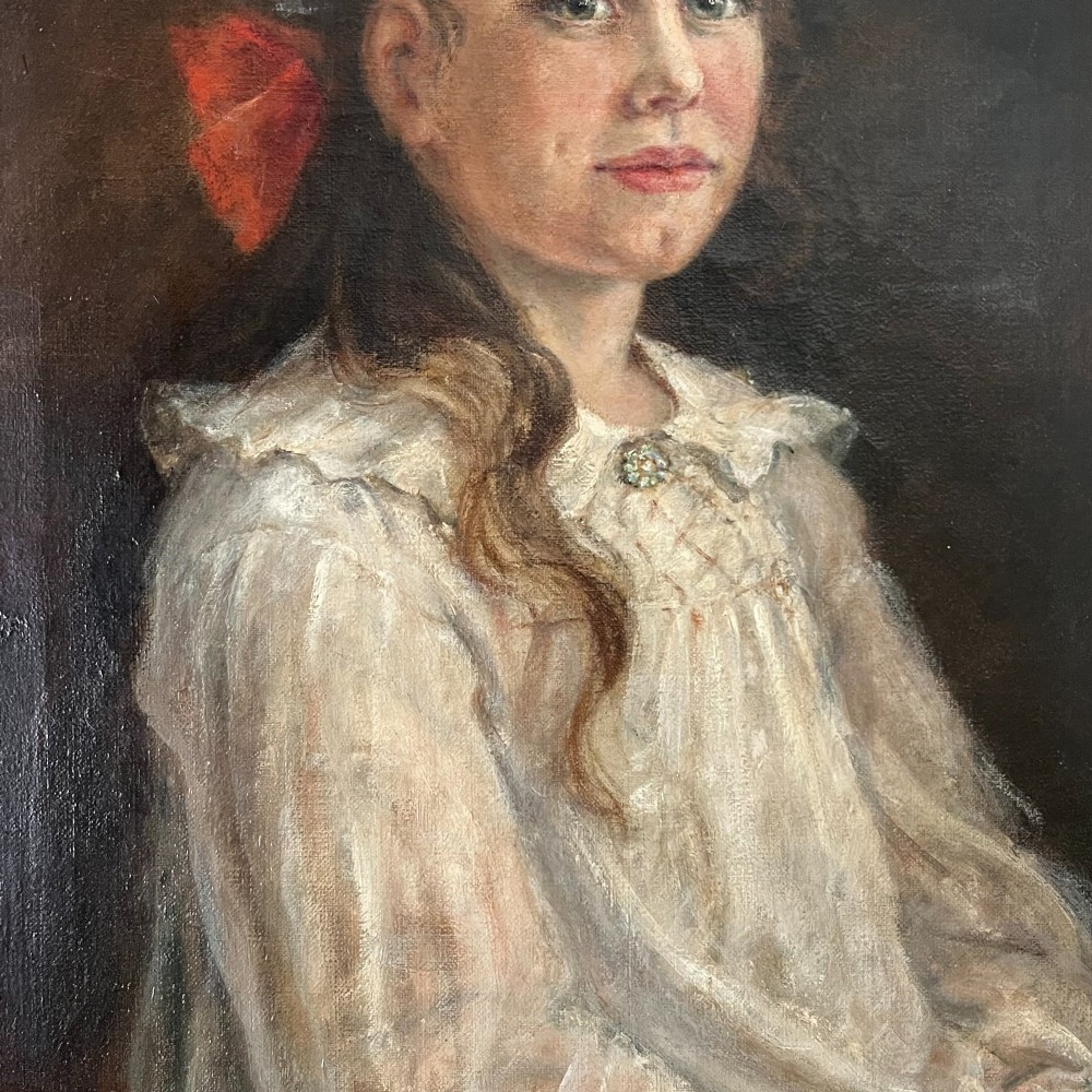 An Edwardian oil painting on canvas featuring a seated young girl in a cream lace-collared dress, housed in a dark wooden frame with a gold inner slip. View III