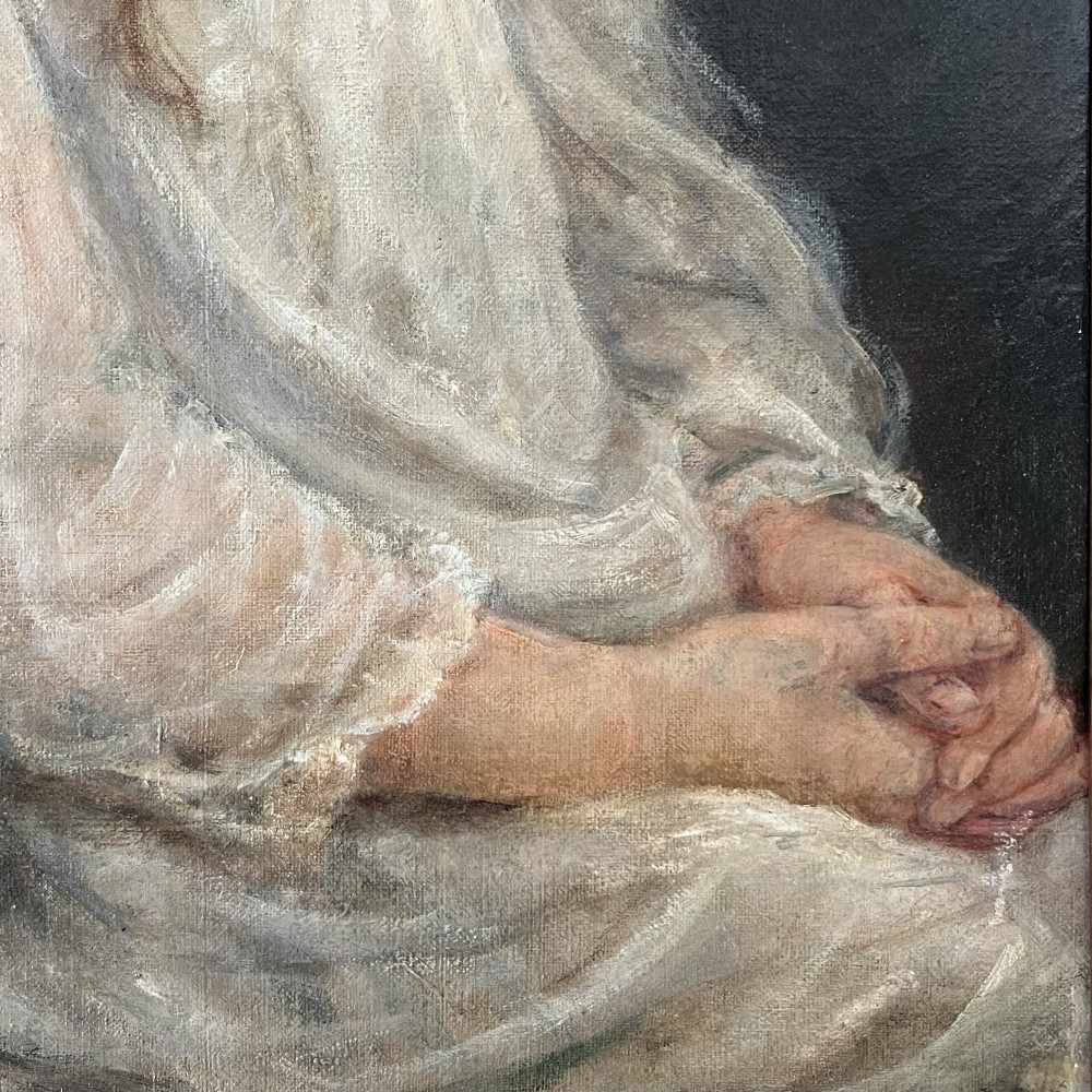 An Edwardian oil painting on canvas featuring a seated young girl in a cream lace-collared dress, housed in a dark wooden frame with a gold inner slip. View IV