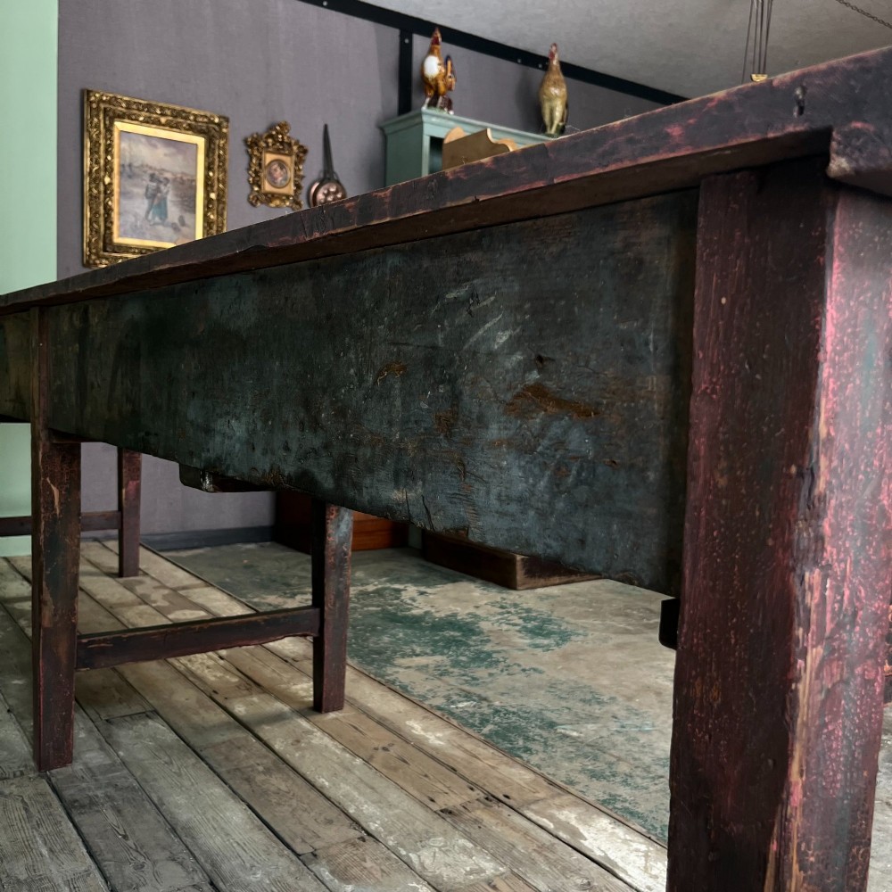 An early 19th-century pine serving table featuring a natural scrubbed timber top and a dark painted base with six legs and four drawers. View VI