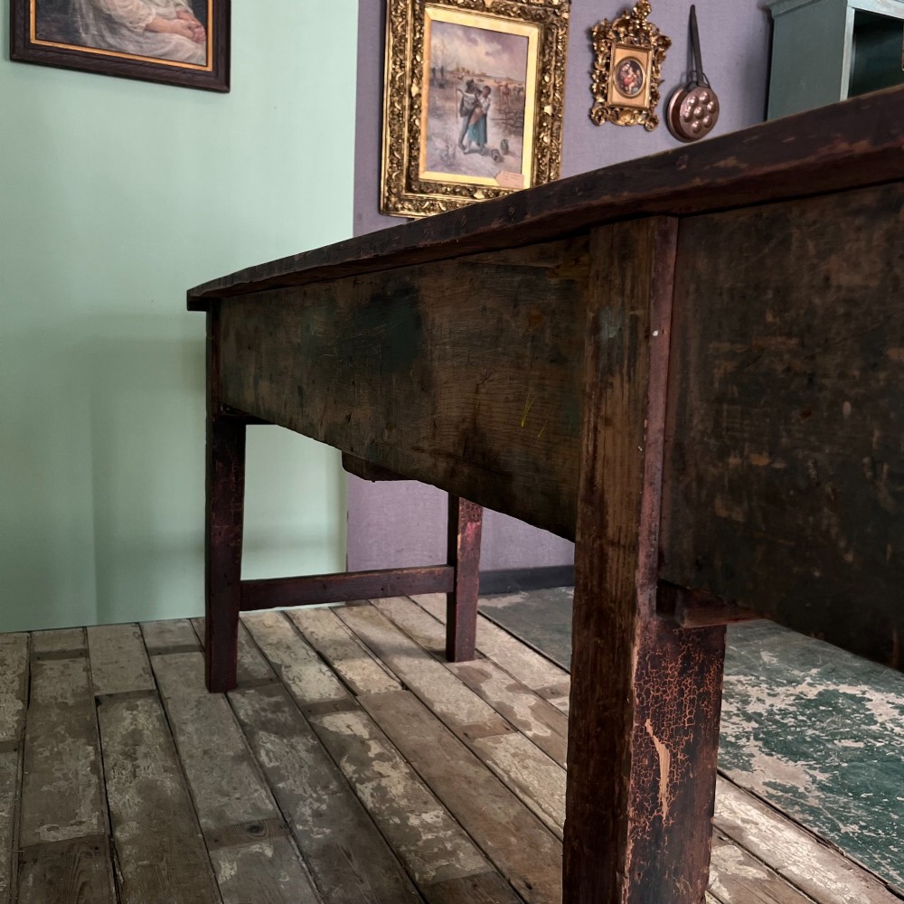 An early 19th-century pine serving table featuring a natural scrubbed timber top and a dark painted base with six legs and four drawers. View VIII