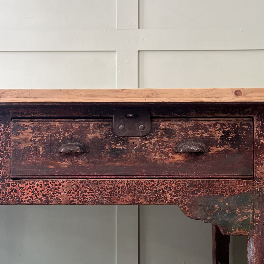 An early 19th-century pine serving table featuring a natural scrubbed timber top and a dark painted base with six legs and four drawers. View IX