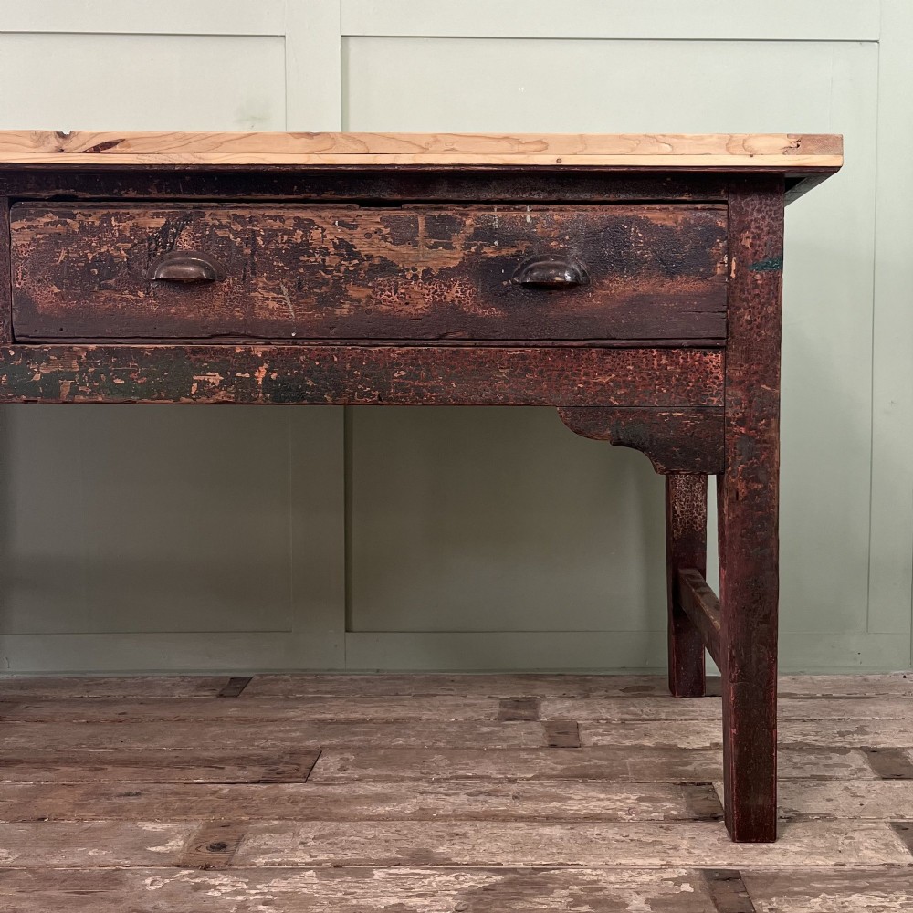 An early 19th-century pine serving table featuring a natural scrubbed timber top and a dark painted base with six legs and four drawers. View XI