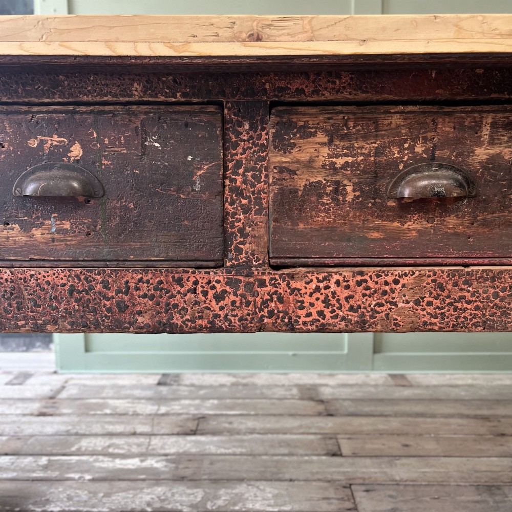 An early 19th-century pine serving table featuring a natural scrubbed timber top and a dark painted base with six legs and four drawers. View XII
