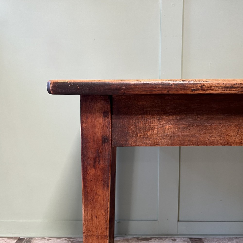 A nineteenth-century French cherrywood farmhouse dining table featuring tapered square legs and a rectangular plank top. View II