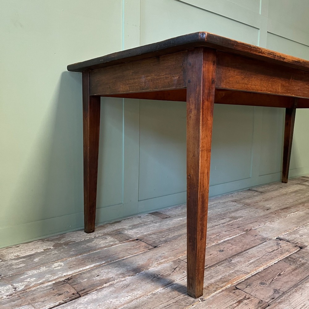 A nineteenth-century French cherrywood farmhouse dining table featuring tapered square legs and a rectangular plank top. View IV