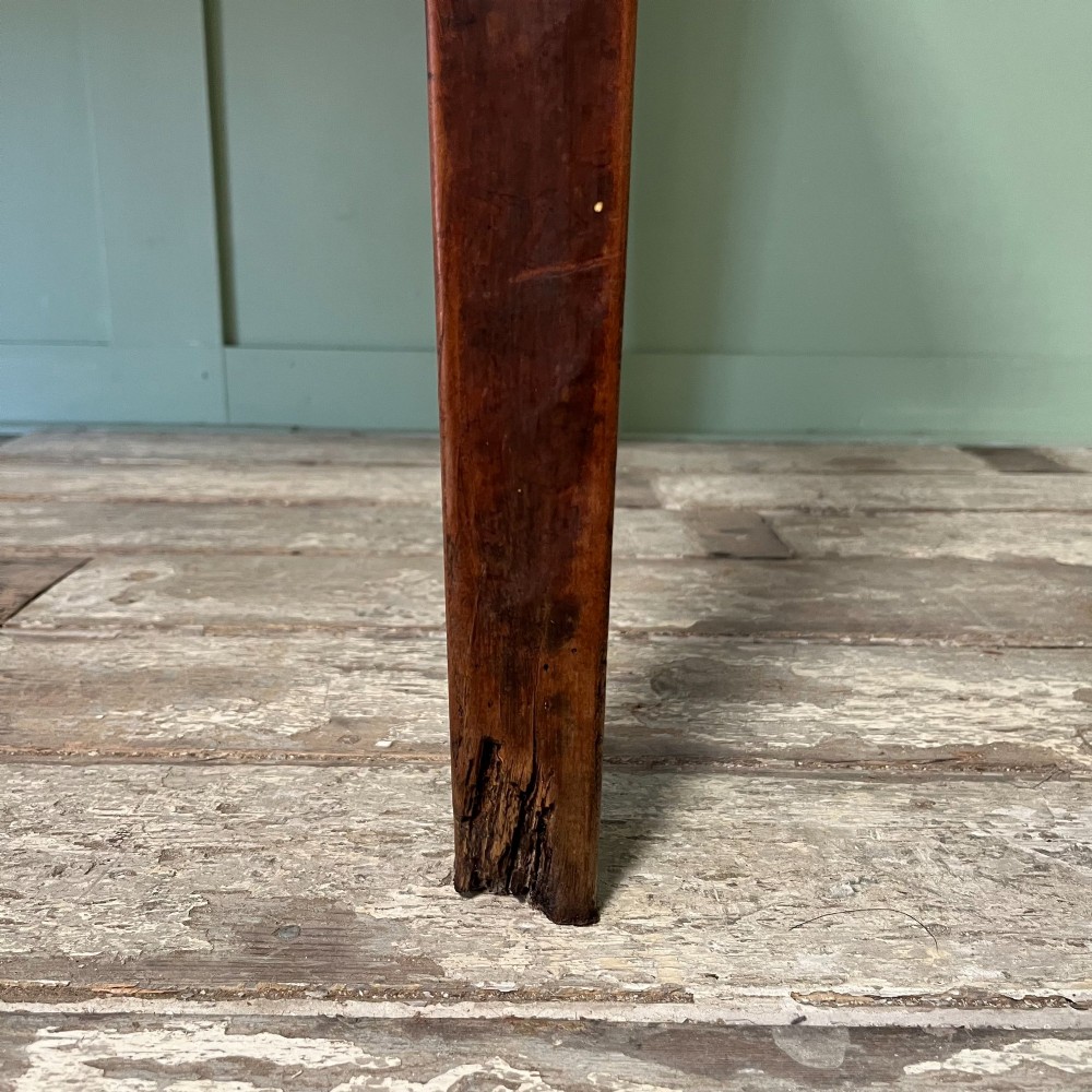 A nineteenth-century French cherrywood farmhouse dining table featuring tapered square legs and a rectangular plank top. View VII