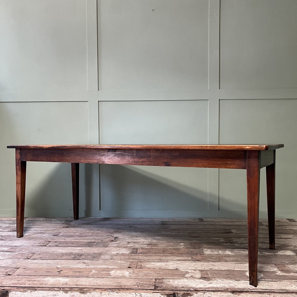 A nineteenth-century French cherrywood farmhouse dining table featuring tapered square legs and a rectangular plank top. View VIII
