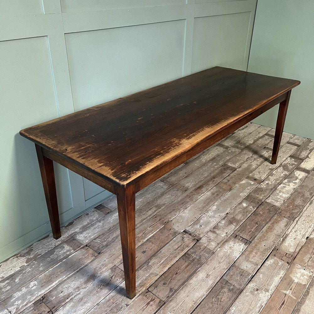 A nineteenth-century French cherrywood farmhouse dining table featuring tapered square legs and a rectangular plank top. View IX
