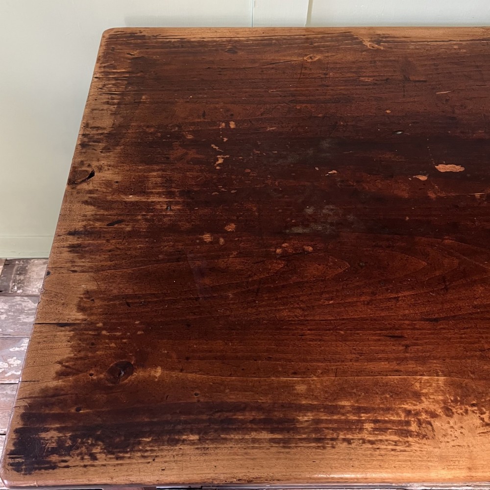 A nineteenth-century French cherrywood farmhouse dining table featuring tapered square legs and a rectangular plank top. View X