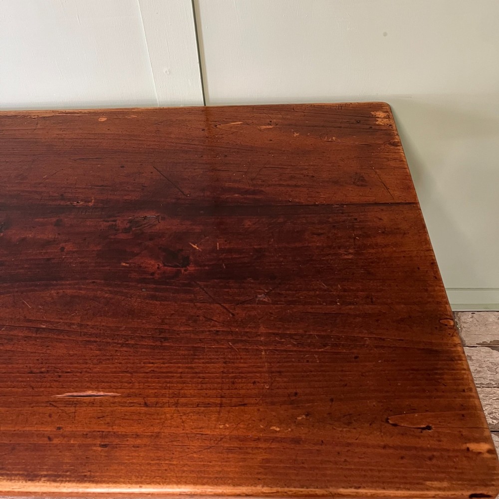 A nineteenth-century French cherrywood farmhouse dining table featuring tapered square legs and a rectangular plank top. View XIII
