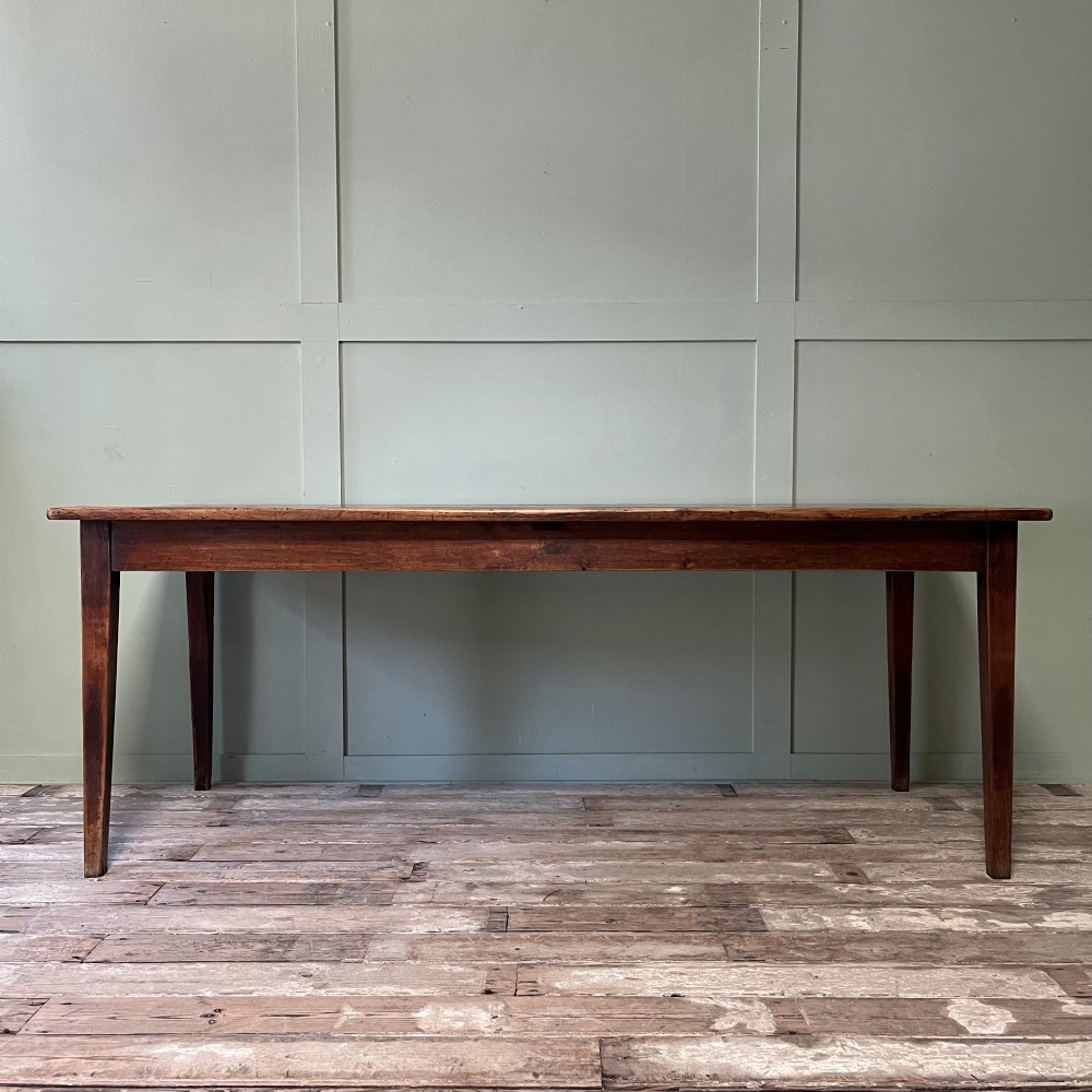 A nineteenth-century French cherrywood farmhouse dining table featuring tapered square legs and a rectangular plank top. View XIV