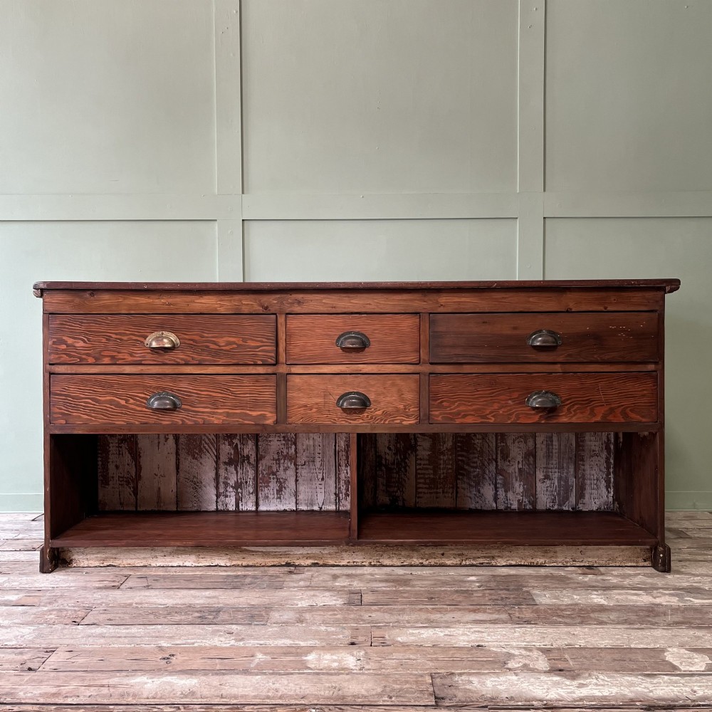 A Victorian shop counter featuring a dark painted pine base with two large glass panel doors and a polished mahogany top surface. View III
