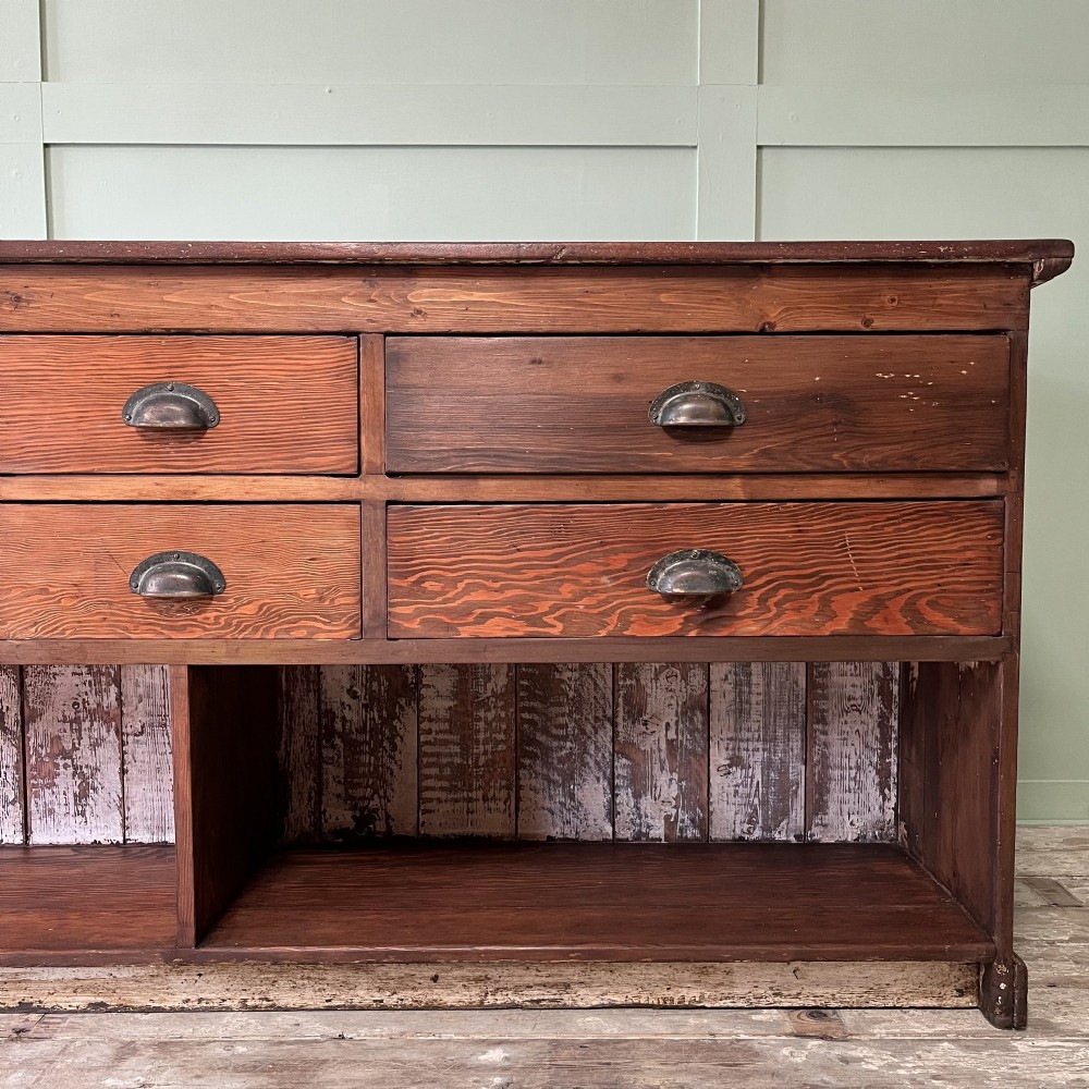 A Victorian shop counter featuring a dark painted pine base with two large glass panel doors and a polished mahogany top surface. View VII