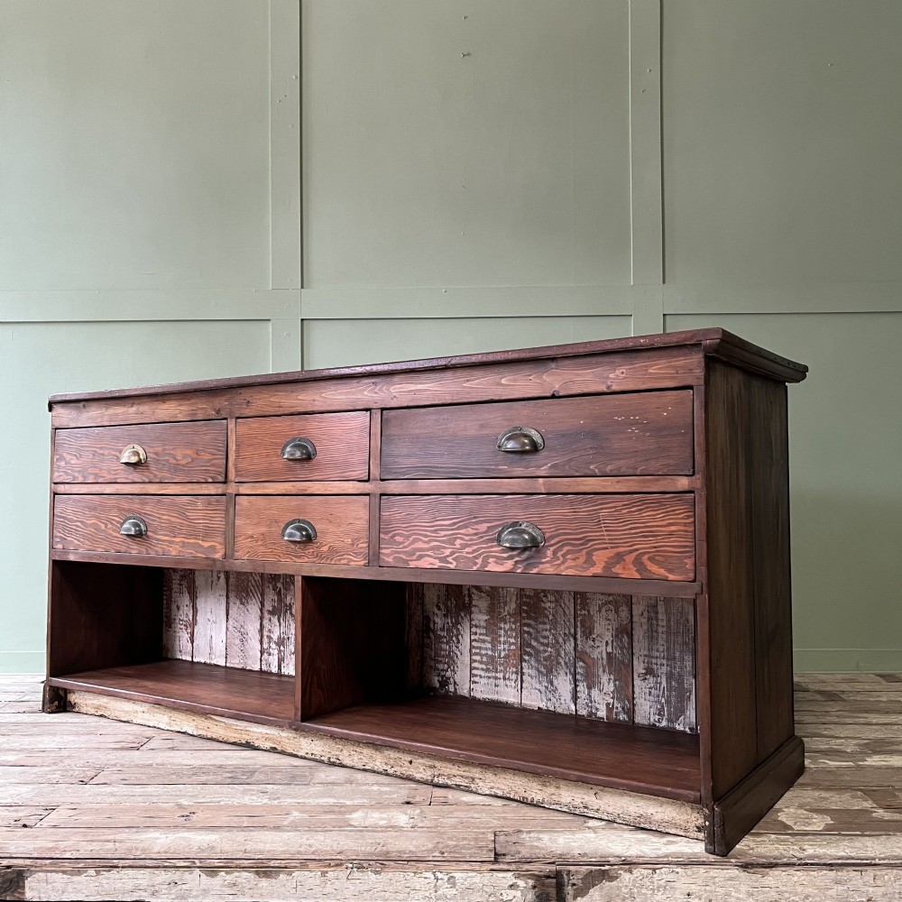 A Victorian shop counter featuring a dark painted pine base with two large glass panel doors and a polished mahogany top surface. View XII
