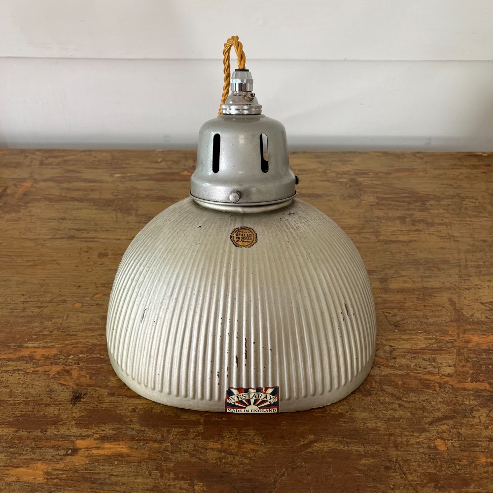 A pair of silver ribbed angled aluminium pendant light shades with vented gallery tops and twisted flex. View III