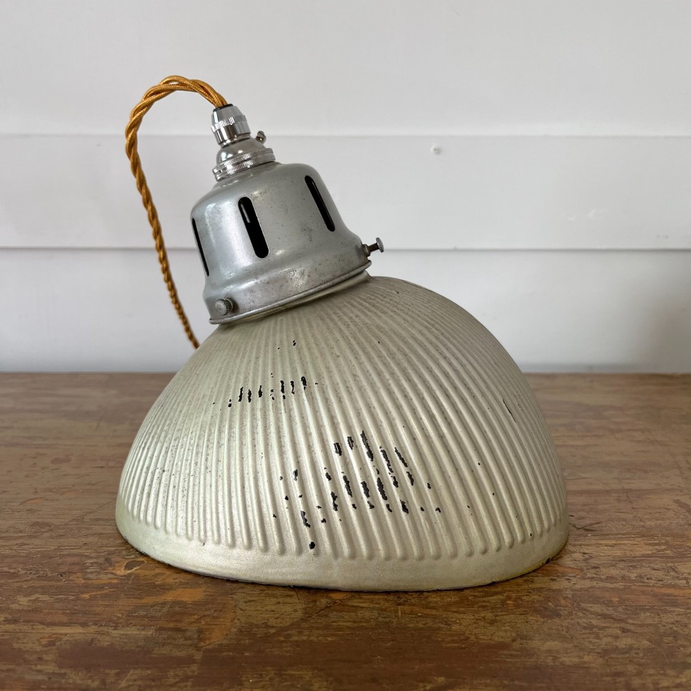 A pair of silver ribbed angled aluminium pendant light shades with vented gallery tops and twisted flex. View IV