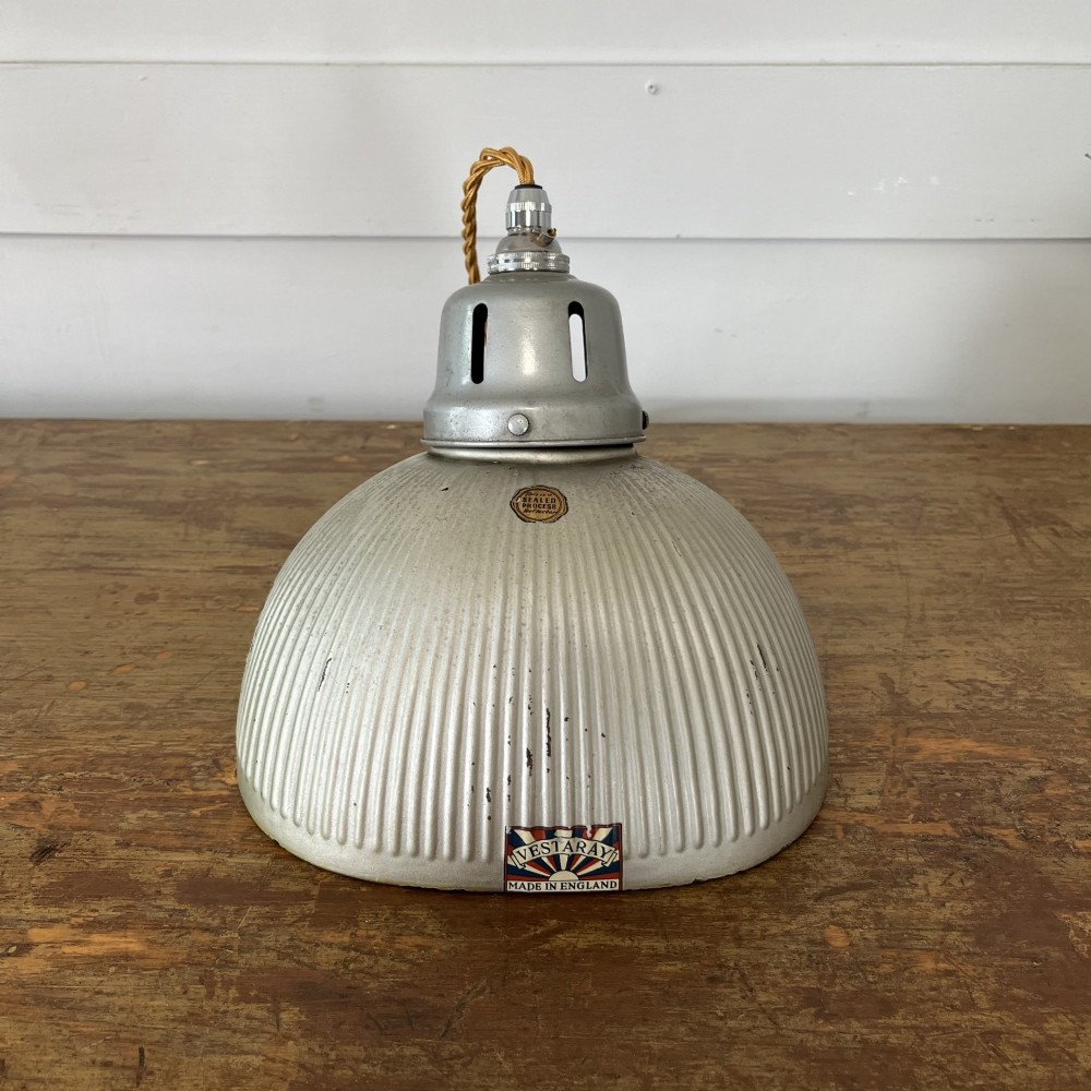 A pair of silver ribbed angled aluminium pendant light shades with vented gallery tops and twisted flex. View VII